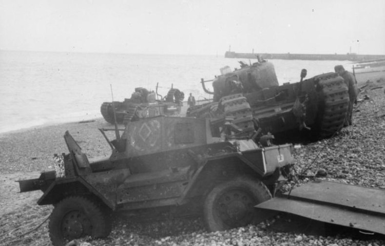 Daimler Dingo armoured car and two Churchill tanks bogged down on the shingle beach