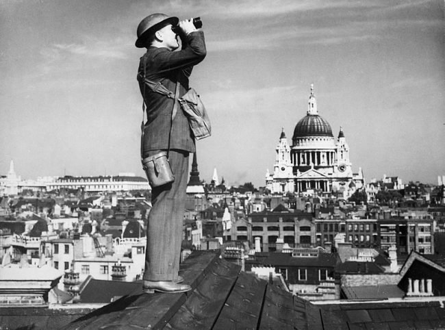 An Observer Corps spotter scans the skies of London during the Battle of Britain.