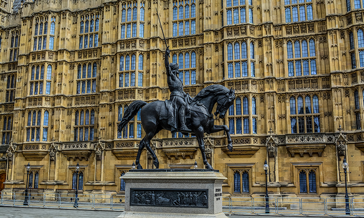 A statue of Richard I on horseback, sword aloft, outside the Houses of Parliament in Westminster